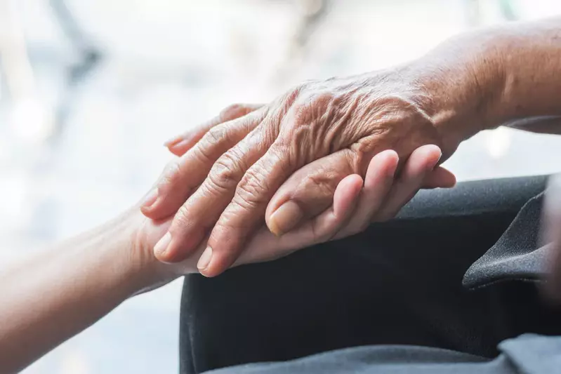 A patient holding someone’s hand