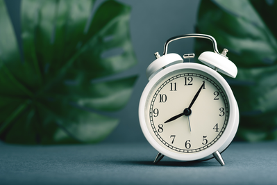 white alarm clock sitting on a side table