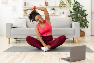 woman stretching on yoga mat