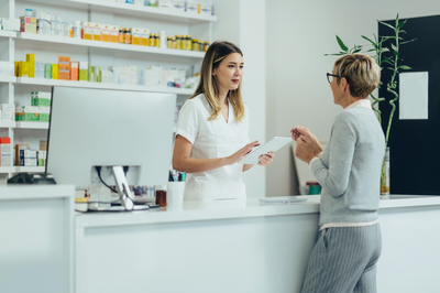 older female patient talking to pharmacist