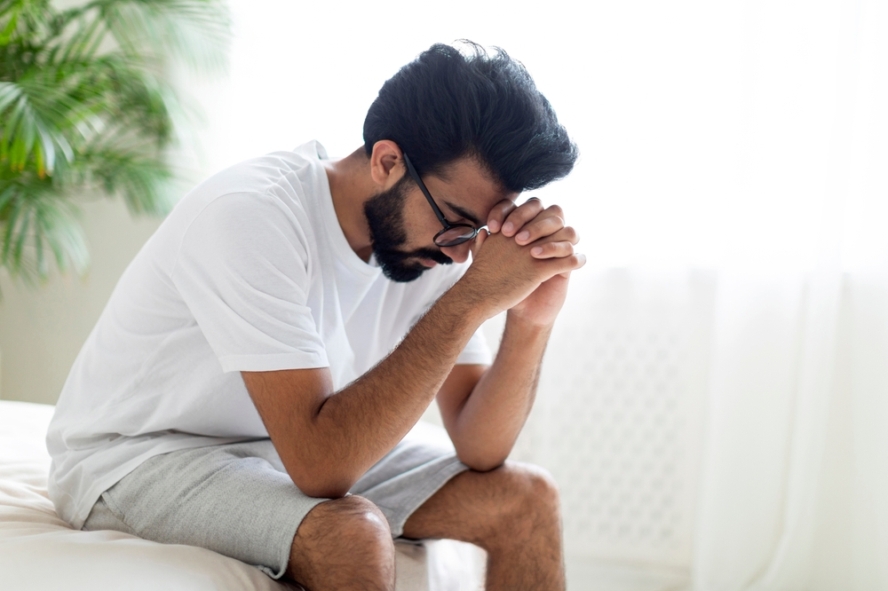 man upset in bed