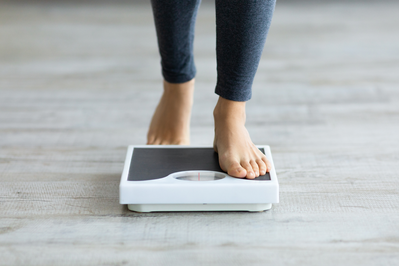 person stepping onto scale
