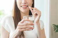 woman taking supplement