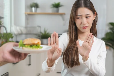 woman rejecting burger