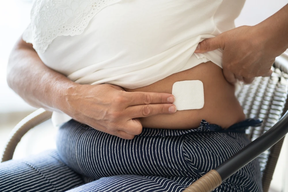 woman with a patch on her abdomen